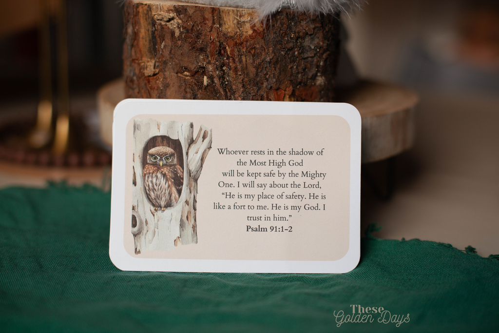 Card with owl illustration and text on a wooden surface