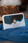 Card with a lantern illustration and text on a blue fabric background