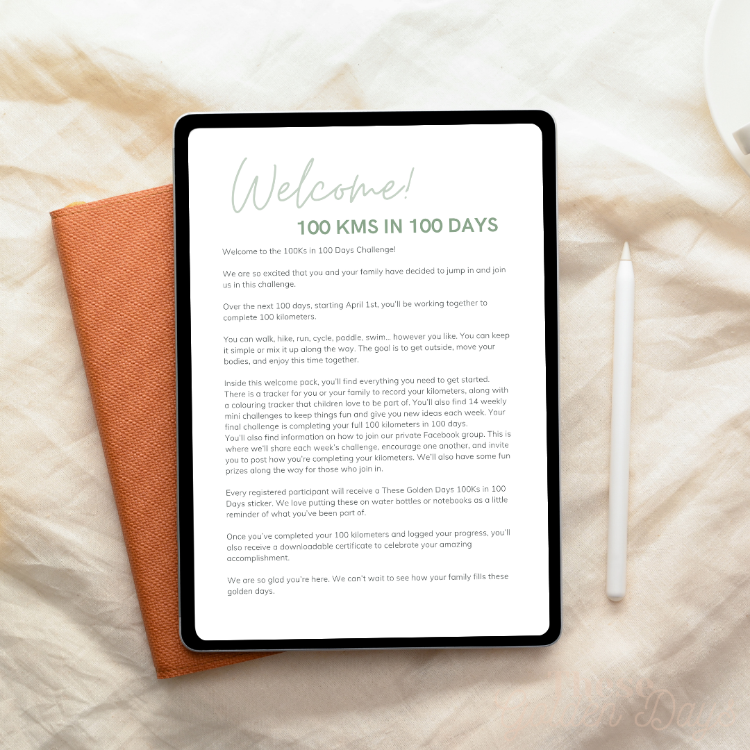 Tablet displaying a welcome message on a textured surface with a pen and notebook.